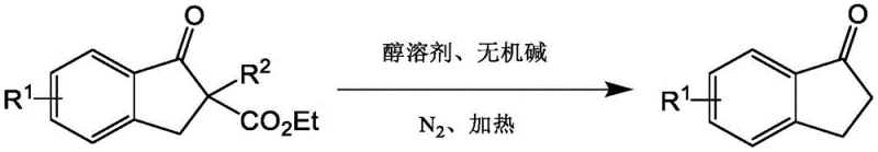 Decarboxylation reaction converting 2-substituted indanone diesters to unsubstituted indanones using HFIP and base